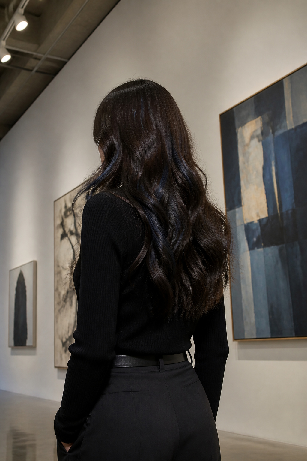 A model with chocolate brown hair featuring subtle indigo lowlights.
