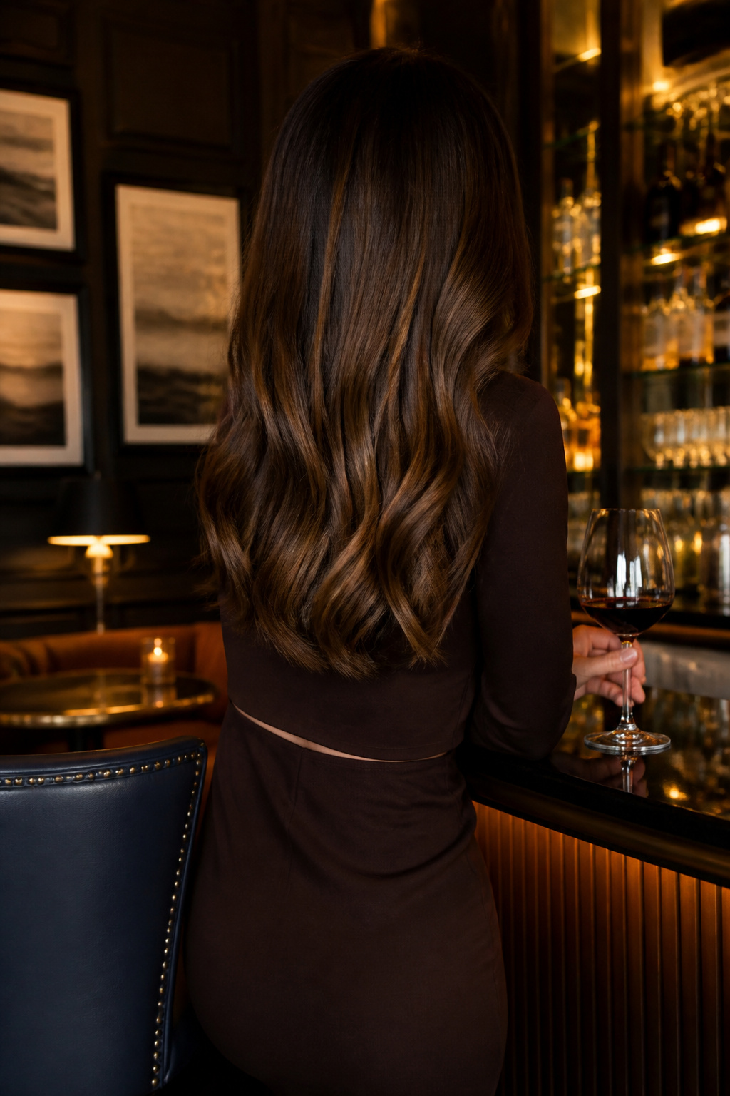 A model with chocolate brown hair featuring translucent gold reflections.