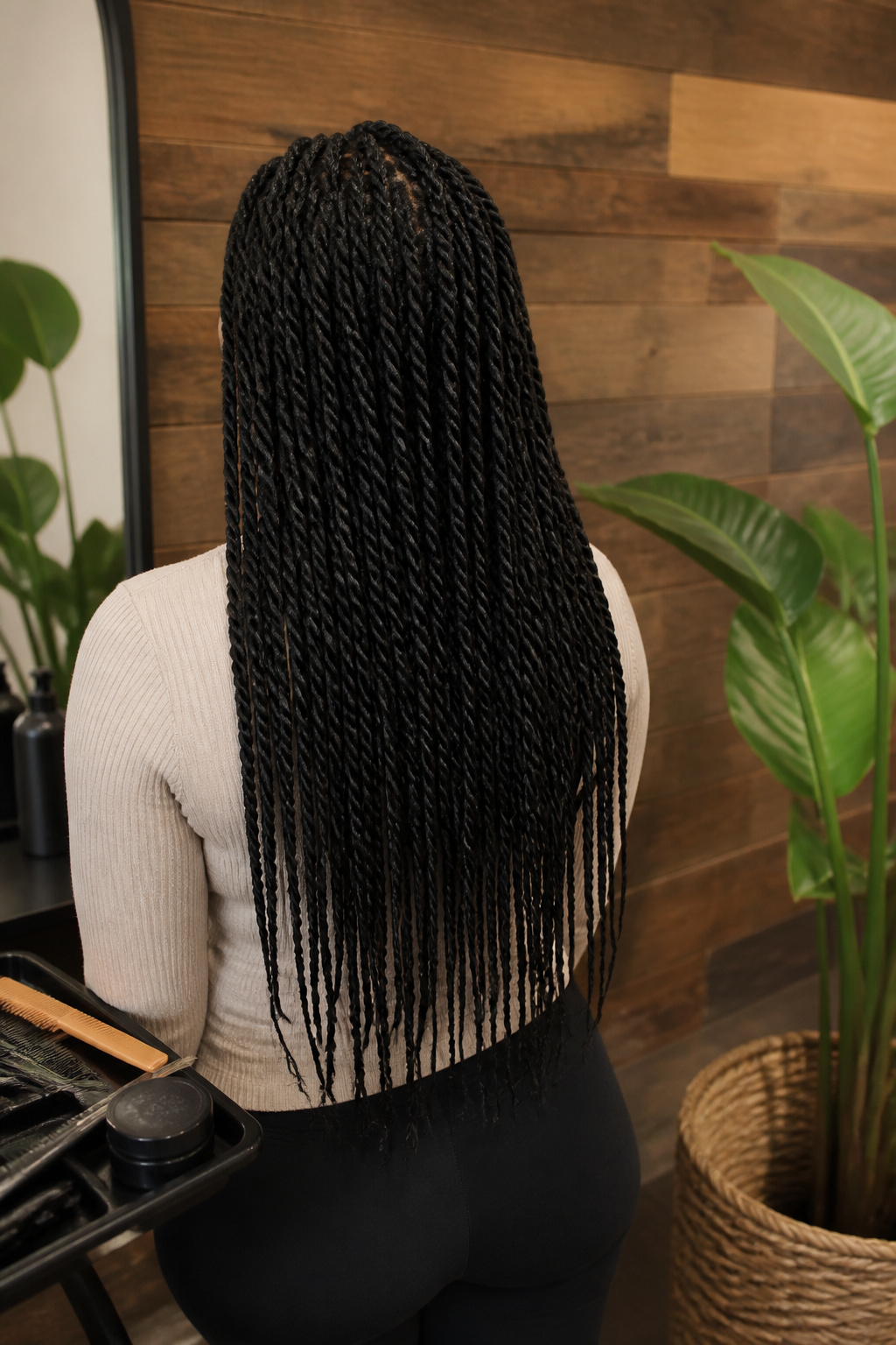 15 Crochet Braids Styles for 2026: From Box Braids to Butterfly Locs 2 Model with shiny Senegalese twists styled in a chic hair studio.